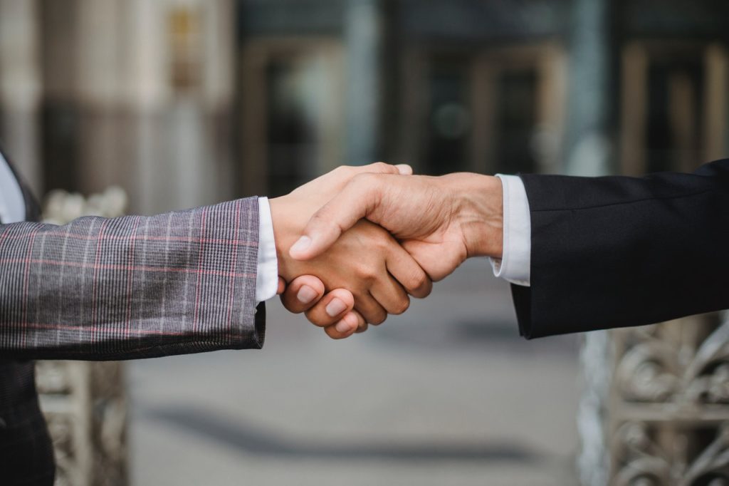 A handshake. This illustrates business networking, one of the ways SEO can help your small business.